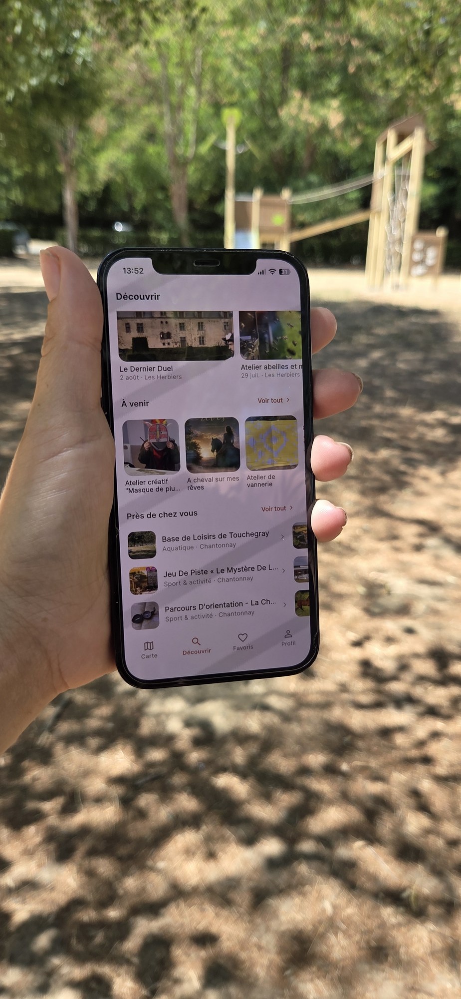 L'application Bouge ta famille ouverte sur un téléphone, dans un parc